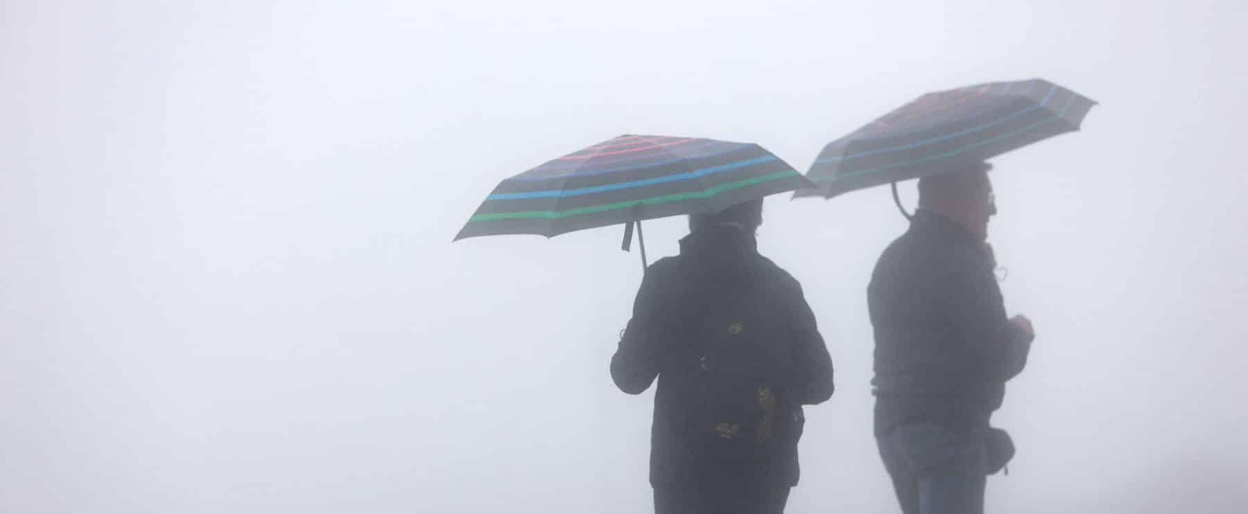 Schierke, Germany. 30th June, 2023. With umbrellas hikers are in the fog and rain on the Brocken. After a rainy Friday, it remains dry towards the weekend. Credit: Matthias Bein/dpa/Alamy Live News